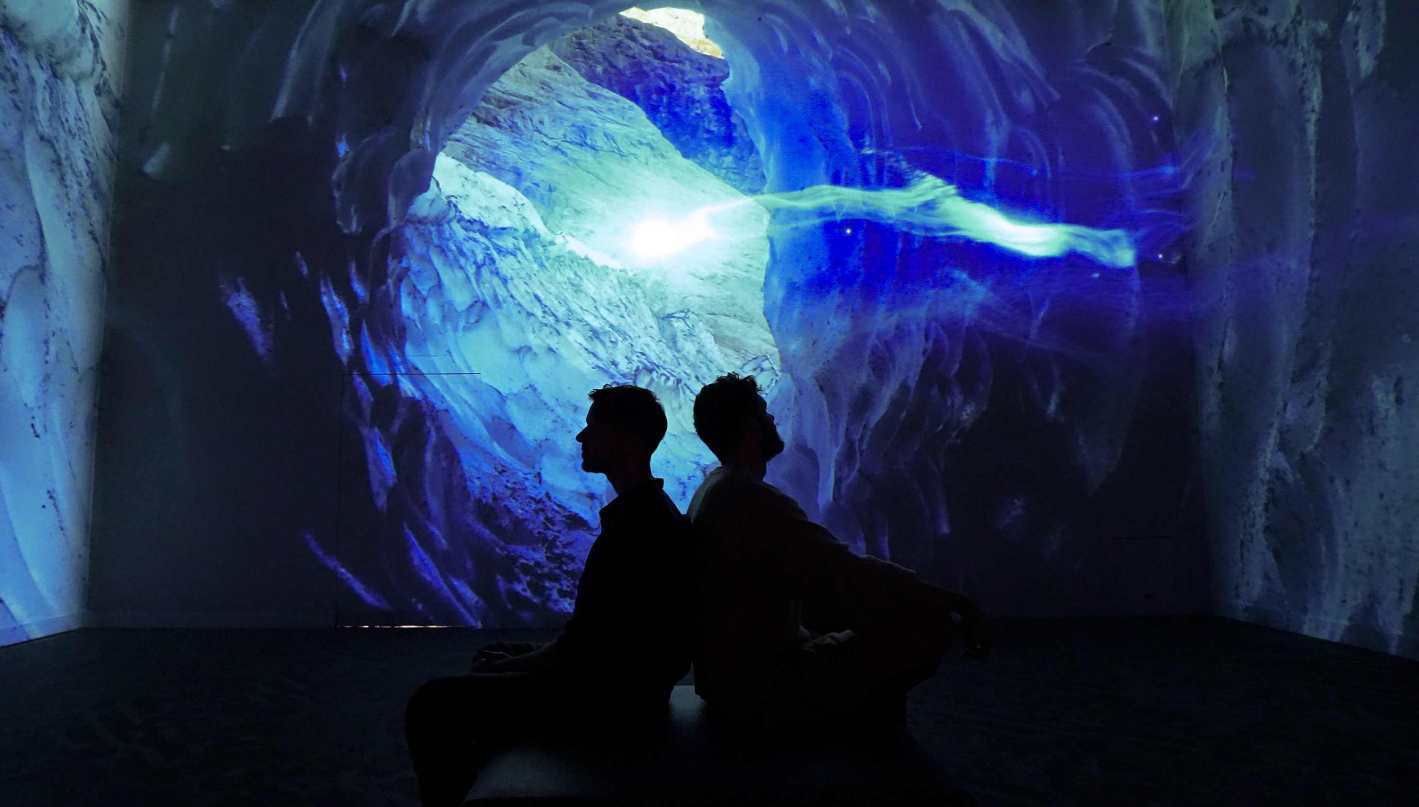 Visitors immersed in Sol Bound I at Frameless London, surrounded by light and landscape projections